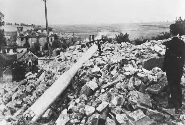 Lidice, Czechoslovakia 10 Jun 1942. SS officer overseeing the destruction of the village. The wreck of St. Martin’s church built in 1732 is still standing in the village center.