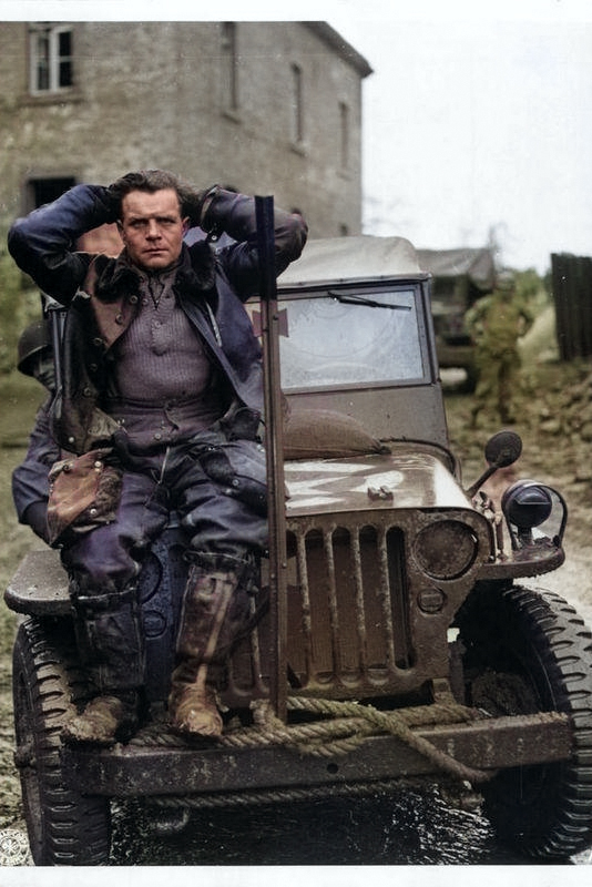 Captured German pilot who was shot down by anti-aircraft fire near Weisweiler, Germany, fall 1944. [Colorized by WW2DB]