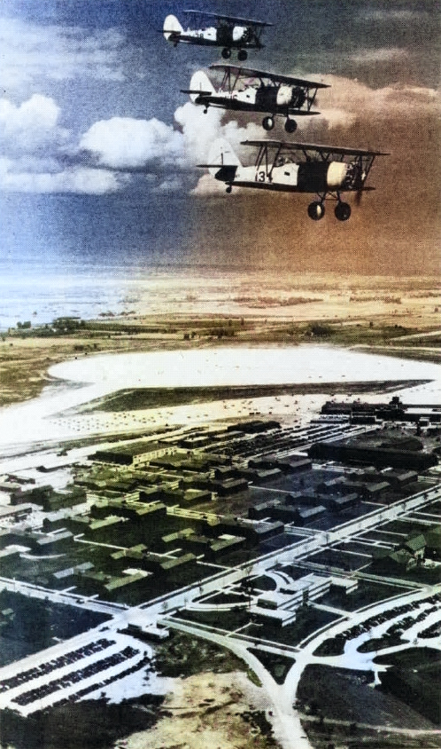 Three N3N aircraft in flight over Naval Air Station Glenview, Illinois, United States, early 1940s; seen in Mar 1980 issue of US Navy publication Naval Aviation News [Colorized by WW2DB]