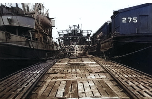 A deck level view of the back of the conning tower of captured German submarine U-505 shortly after arrival at Bermuda, 19 to 29 Jun 1944. Fleet tug USS Abnaki is at left and covered lighter YFN-275 is at right. [Colorized by WW2DB]