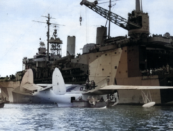 PBM-3 Mariner aircraft of US Navy patrol bomber squadron VPB-210 being prepared for hoisting aboard seaplane tender Albemarle, Guantanamo Bay, Cuba, 5 Jan 1945 [Colorized by WW2DB]