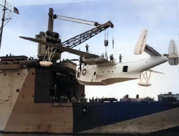 PBM-3 Mariner aircraft of US Navy patrol bomber squadron VPB-210 hoisted aboard seaplane tender Albemarle, Guantanamo Bay, Cuba, 5 Jan 1945 [Colorized by WW2DB]