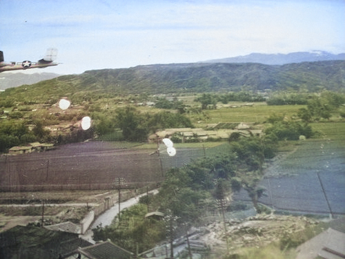 Toyohara Airfield under US parafrag attack, Taichu (now Taichung), Taiwan, 1945, photo 1 of 2 [Colorized by WW2DB]