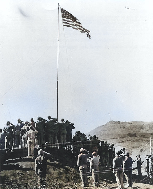 The official flag raising at the American Headquarters on Iwo Jima immediately after Nimitz's proclamation of victory, 14 Mar 1945 [Colorized by WW2DB]