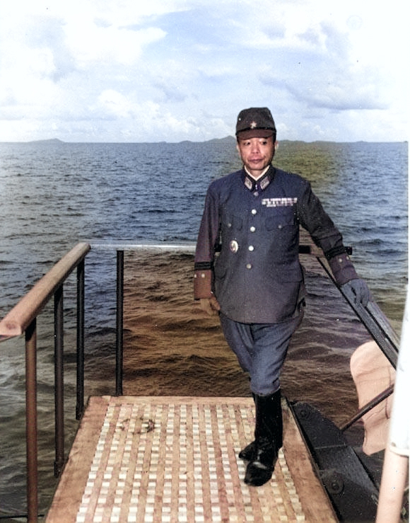 Lieutenant General Shunzaburo Mugikura aboard Portland to surrender Truk, Caroline Islands, which is visible in background, 2 Sep 1945 [Colorized by WW2DB]