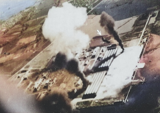 Seaplane hangars under US Navy carrier aircraft attack, Toko Bay (now Dapeng Bay), southern Taiwan, 12 Oct 1944, photo 2 of 7 [Colorized by WW2DB]