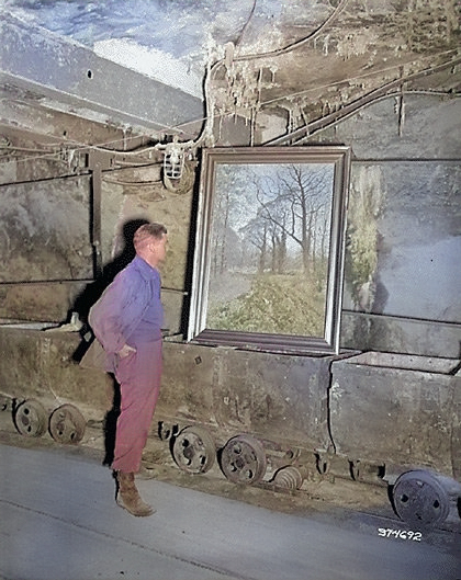 US Army Corporal Donald Ornitz examining a looted painting in the Merkers salt mine, Germany, Apr 1945 [Colorized by WW2DB]