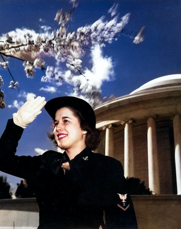 WAVES Specialist (P) 3rd Class saluting near the Jefferson Memorial, Washington, DC, United States, during WW2; note the cherry blossoms, indicating the photograph was taken in the spring [Colorized by WW2DB]