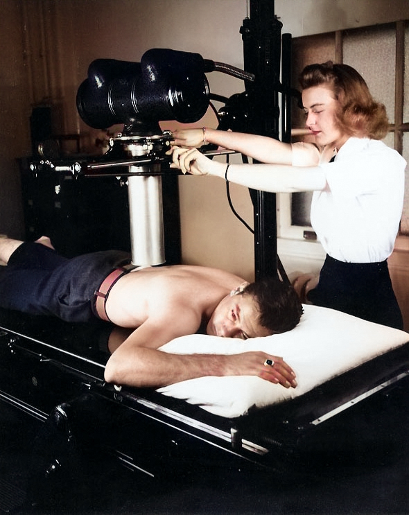 WAVES Pharmacist's Mate 3rd Class Winifred Perosky X-Rayed USMC Private First Class Harold Reyher, who was wounded at Iwo Jima, Naval Hospital, San Diego, California, United States, spring 1945 [Colorized by WW2DB]