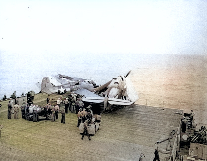 FM-1 aircraft having crashed into several TBF aircraft while landing on the flight deck of USS Coral Sea, 11 Oct 1943, photo 2 of 3 [Colorized by WW2DB]