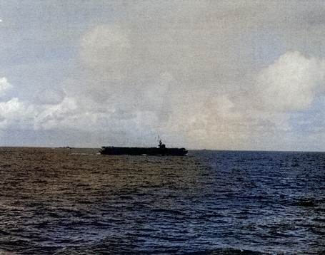 USS Coral Sea a short distance off Kwajalein Atoll, Marshall Islands, 1 Feb 1944; photo taken from USS Manila Bay [Colorized by WW2DB]