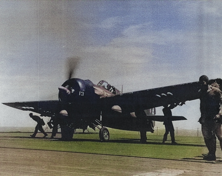 Armorers equipping a F4F Wildcat fighter with HVAR rockets aboard USS Anzio, 20 Apr 1945 off Okinawa. [Colorized by WW2DB]