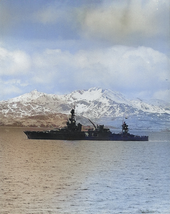 Louisville steamed out of Kulak Bay, Adak, Aleutian Islands, bound for operations against Attu, 25 Apr 1943; note Sweepers Cove in background [Colorized by WW2DB]