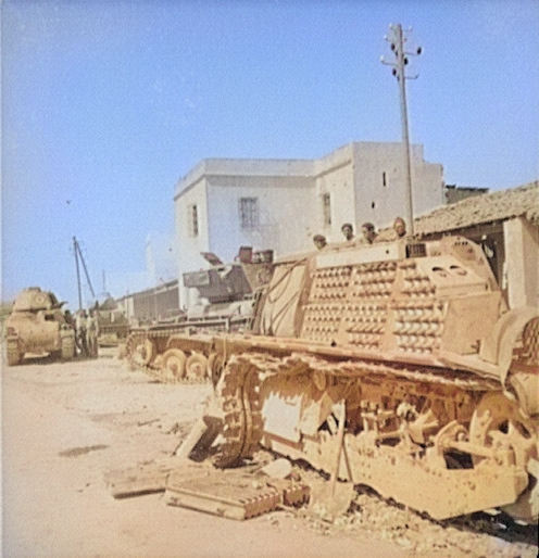 Dismantled French AMC 35 S medium tank, Porto Farina, Tunisia, May 1943; two more AMC 35 S tanks and a Valentine Mk III tank in background [Colorized by WW2DB]