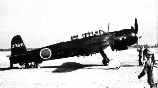 A mechanic manually turning the engine on a B6N2 torpedo bomber to prevent hydraulic lock, 1940s