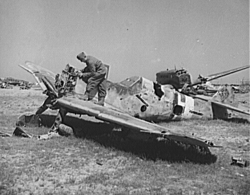 A French soldier looking over the wreckage of a German Bf 109 fighter at the El Aouiana airfield, Tunisia, circa May-Jun 1943