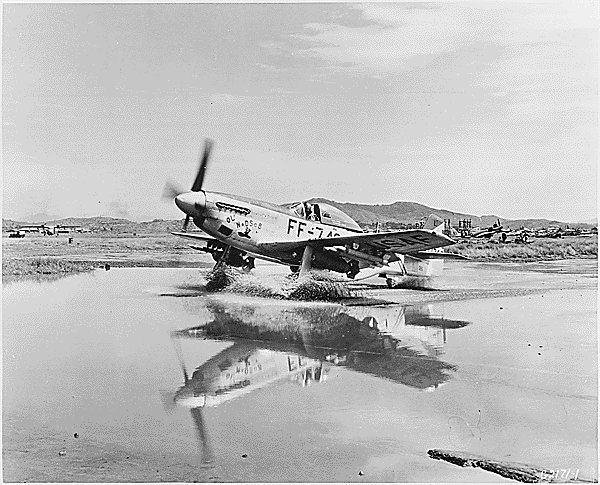 F-51 Mustang fighter taxiing through a puddle, Korea, circa Sep 1951