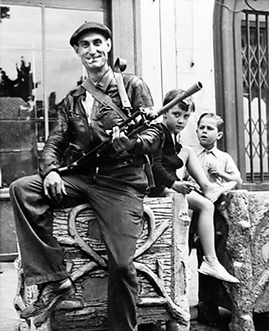 Member of the French Forces of the Interior (FFI) posing with his Bren gun, Chateaudun, Eure-et-Loir, France, Aug 1944