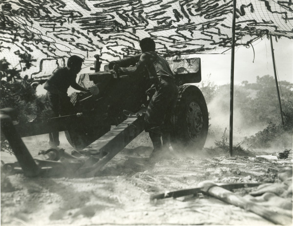 Japanese-American soldiers of US 442nd Regimental Combat Team firing a 105-mm howitzer, Castellina Sector, Livorno, Italy, 12 Jul 1944