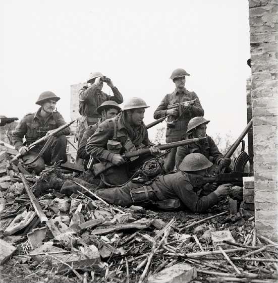 Lieutenant I. Macdonald (with binoculars) of 48th Highlanders of Canada regiment at San Leonardo di Ortona, Italy, 10 Dec 1943; the soldiers were, left to right, Sergeant J. T. Cooney, Private A. R. Downie, Private O. E. Bernier, Private G. R. Young, Corporal T. Fereday, and Private S. L. Hart