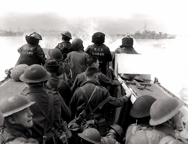 Canadian infantrymen aboard a landing craft launched from HMCS Prince Henry, off Normandy beach, France, 6 Jun 1944