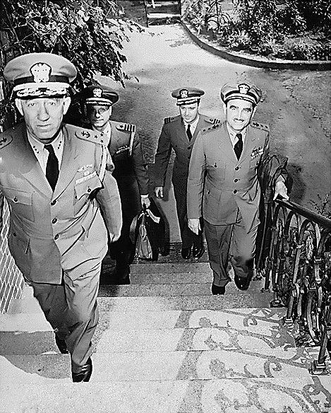 US Navy FAdm King's staff going to their quarters during Potsdam Conference, Germany, 15 Jul 1945; top to bottom: VAdm G. M. Cooke, RAdm H. L. Naples, Captain A. S. McDill, Commander E. J. Gough