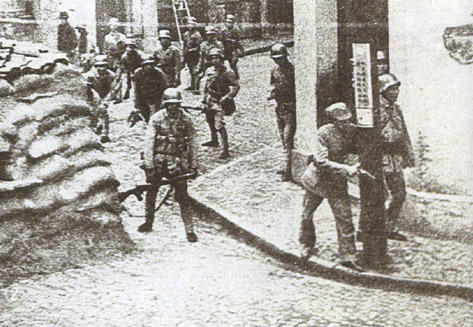 Soldiers of Chinese 88th Division gathering at a street corner in Shanghai, China, 1937