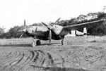 A P-38 Lightning with the 80th Fighter Squadron, the “Headhunters,” at rest at Dobodura, New Guinea, Dec 1943 – Feb 1944. Note the improvised wheel chocks.