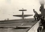 A TBM Avenger catches its propeller in the barrier wires and noses over after landing aboard the training aircraft carrier USS Sable on Lake Michigan, United States, 1945.