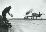 F6F Hellcat coming in for a landing on the training aircraft carrier USS Sable on Lake Michigan, United States, 1945.  Note the LSO’s “paddles” and the lack of extended tailhook on the Hellcat.