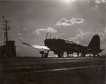 Arresting wires are disengaged from an SB2U Vindicator following a landing aboard the training aircraft carrier USS Sable on Lake Michigan, United States, 1943-44.