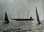 The training aircraft carrier USS Wolverine steams past two sailboats on Lake Michigan, United States, 1943.