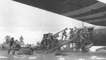 British troops loading an Ordinance QR six-pound field gun through the side door of a Horsa I glider, location unknown, 1944.