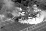 Ensign Ardon R. Ives of Fighting-Bombing Squadron VBF-9 crashed his F6F-5 Hellcat through the barrier on USS Lexington (Essex-class) and ruptured the center-line fuel tank, Feb 1945, western Pacific. Photo 6 of 7