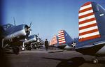 A security guard standing among OS2U-3 Kingfishers staged for delivery to the US Navy, Stratford, Connecticut, United States, early 1942