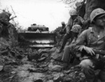 M4 Sherman tank fitted with a bulldozer blade supporting US Marine infantry on Iwo Jima, 9 Mar 1945.