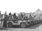 During a Rest & Relaxation period, United States Army personnel pose for keepsake photographs in front of the Great Pyramids of Giza, Egypt, 13 Dec 1942.