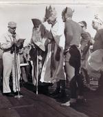 Captain Carlos Wieber bids welcome to the Ruler of the Raging Main, Neptunus Rex, and his Court aboard USS Essex for the Line Crossing ceremony, 1 Sep 1944