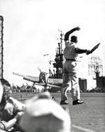 The tail of an F6F Hellcat of Fighting Squadron VF-25 being yanked to the deck as the tailhook catches a wire aboard the USS Cowpens off Makin Atoll (now Butaritari), 20 Nov 1943