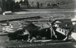 With the fires out, crews evaluate how to make emergency repairs to a large hole in Ticonderoga’s flight deck from a special attack aircraft crashing through it off Formosa (Taiwan) on 21 Jan 1945