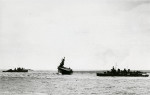 The USS Yorktown (Yorktown-class) listing 20-degrees from damage off Midway, 4 Jun 1942. Yorktown had already been abandoned with survivors picked up by USS Hammann (right) and other escorts.