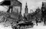 French troops and H35 tanks advancing through a damaged village during the invasion of France, 25 May 1940.