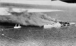 Italian cruiser San Giorgio after being scuttled in the harbor at Tobruk, Libya as Australian troops entered the city, 22 Jan 1941. Note torpedo nets. Photo 2 of 2.