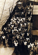 Crew of USS Oahu at prayer upon hearing the news of Japanese surrender, Eniwetok Atoll, Marshall Islands, 15 Aug 1945