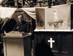 US Navy Chaplain D. C. Crummey holding religious service aboard USS Estes, 15 Aug 1945