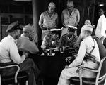 Surrender negotiations at Mili Atoll, Marshall Islands, aboard USS Levy, 19 Aug 1945; L to R: Cdr H.E. Cross, Majuro commander Capt H.B. Grow, LtCdr Toyda and Lt Hutsu, Lt Col G.V. Burnett (only cap showing), and others