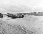 Razorback P-47D Thunderbolt of the 373rd Fighter Group after skidding to a stop on the sand of a Normandy beach, France, 14 Jun 1944.