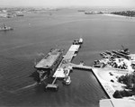 Aircraft transport USS Long Island at North Island, San Diego, California, United States, 2 Jun 1942. Note F4F-4 Wildcats and SOC-3A Seagulls on the flight deck.