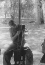 Member of 613th Field Artillery Battalion, US 5332nd Brigade (Provisional) Covault working on a piece of leather, Burma, 1945