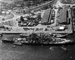 United States battleship USS Wisconsin at the Pearl Harbor Naval Base tying up alongside the hulk of the battleship Oklahoma, which had been decommissioned just two months earlier, 11 Nov 1944.